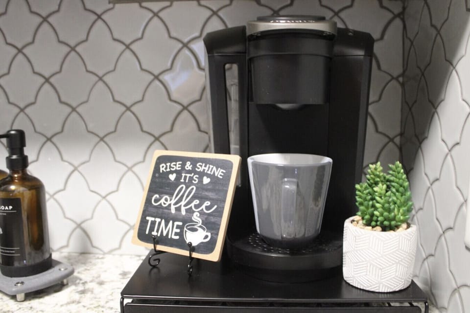 Coffee Corner: Start your day right with our Keurig and charming decor waiting for you.