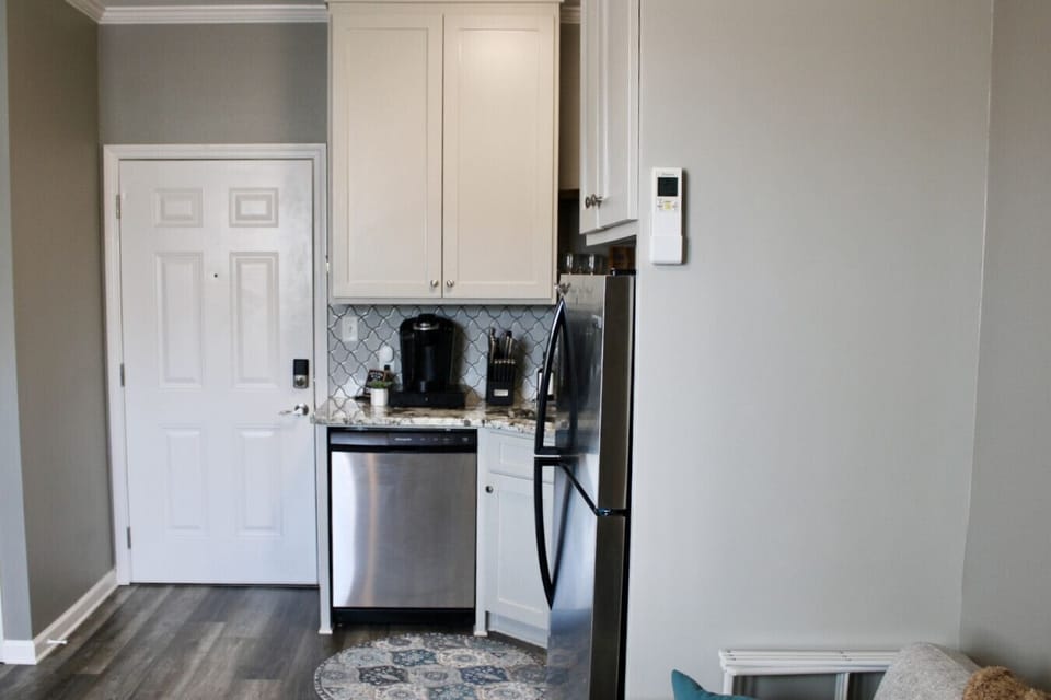 Kitchen: Sleek appliances and stylish decor make cooking a delight in this charming kitchen.