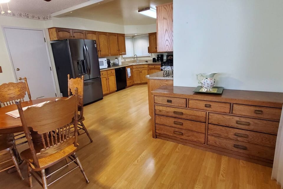 Cozy room featuring a wooden cabinet and dining table.