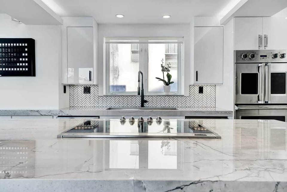 3rd FLOOR: KITCHEN. 30 foot island. Viking appliances (double oven, warmer, full fridge, wine fridge, dishwasher, drawer microwave, 6 burner cooktop with retractable vent, dishwasher), built-in Miele espresso machine. 48 inch sink. 