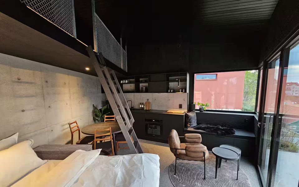 Open-plan interior with designer kitchen, dining space, and lounge corner