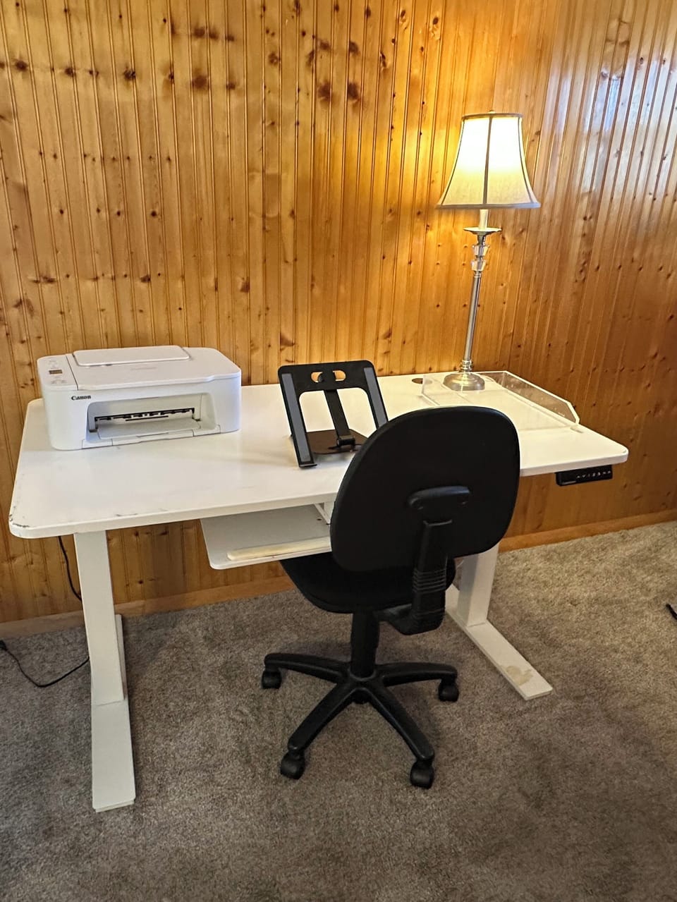 Designated work space with standing or sitting desk. Printer, included