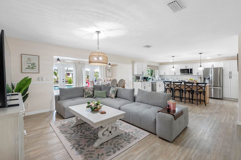 Relax in this inviting living room, featuring a plush sectional sofa perfect for movie nights on the large smart TV.