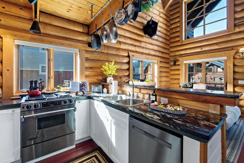 Cook with ease in a chef’s kitchen framed by rustic log cabin charm
