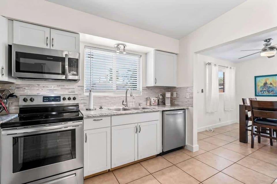 Cook up your favorites in this stylish and fully-equipped kitchen featuring stainless steel appliances, a spacious dual-basin sink, Keurig coffee maker, and sleek quartz countertops. 