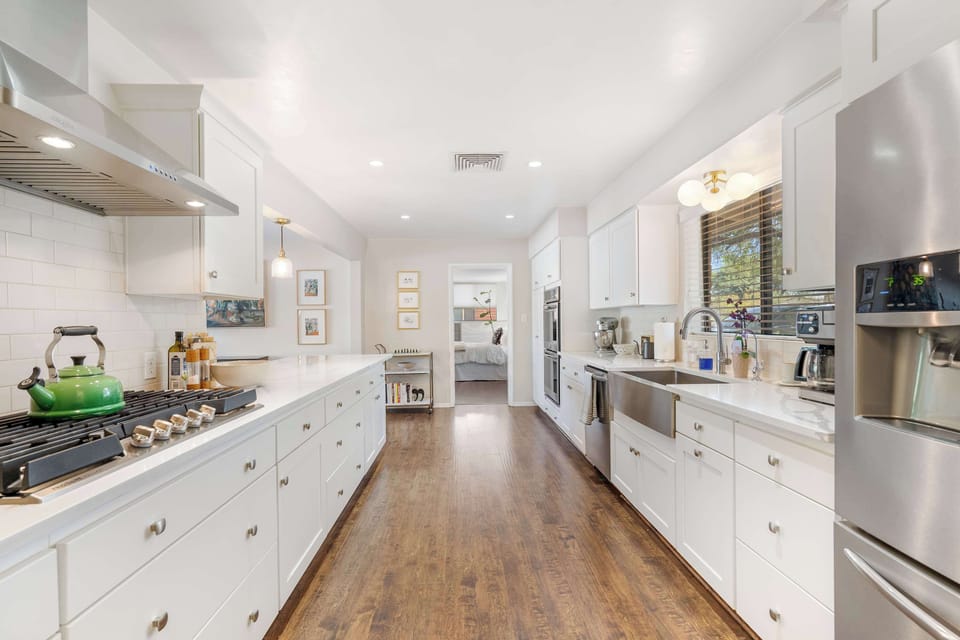 Spacious, fully-equipped kitchen with modern appliances and ample counter space, perfect for preparing delicious meals.