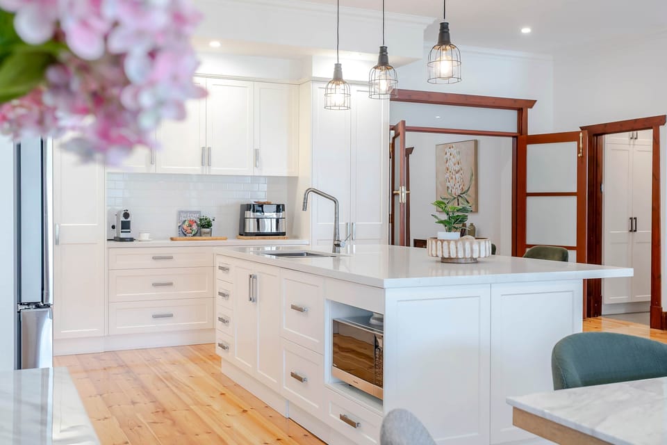 Kitchen Dreams - Two double door pantry’s, appliance cupboard, microwave nook and dual sinks.