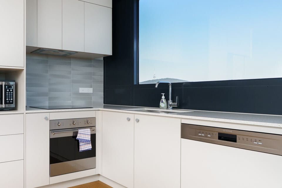 Functional, spotless kitchen with sleek countertops and modern appliances