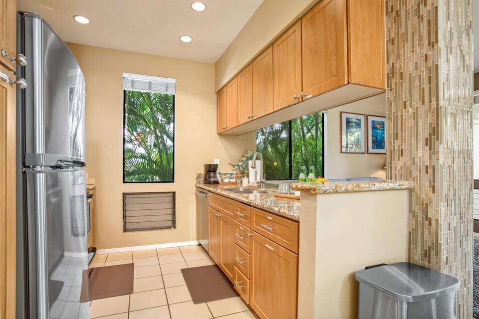 Functional kitchen with sleek countertops and natural light GCH-181