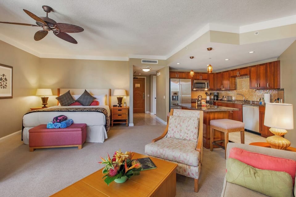 Bright island-style living room with plush seating, tropical views, and direct lanai access for ocean breezes HKH-323