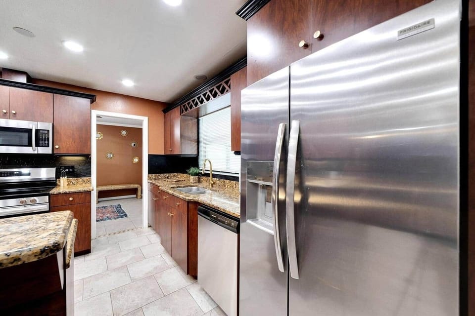 Full kitchen with tile flooring. Stainless Steel appliances. 