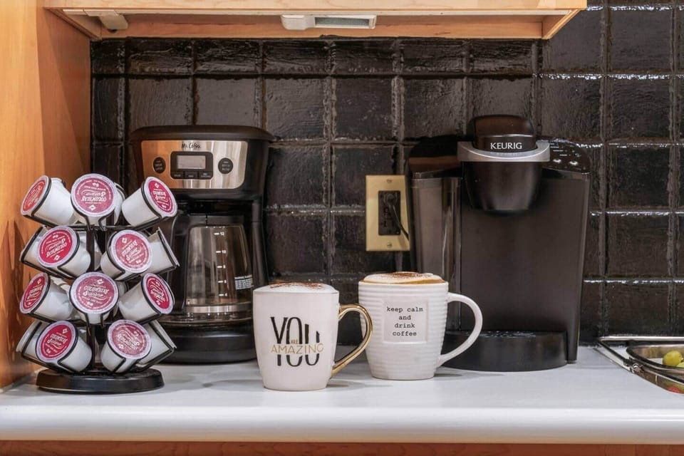 A cozy coffee station with a Keurig machine, a drip coffee maker, and a selection of coffee pods.