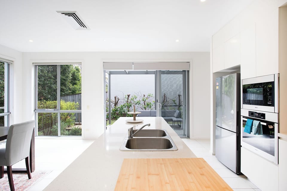 Sleek open kitchen and dining area with seamless indoor-outdoor flow.