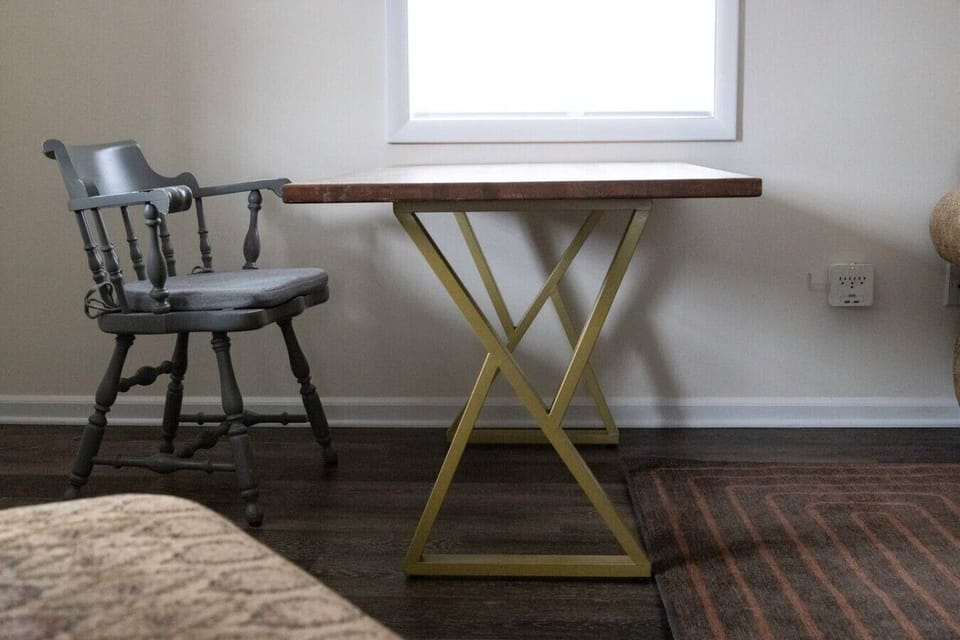 Living room features a refinished oak wood table with modern gold metal legs, perfectly positioned for working, watching TV, or socializing. 🪑✨📺