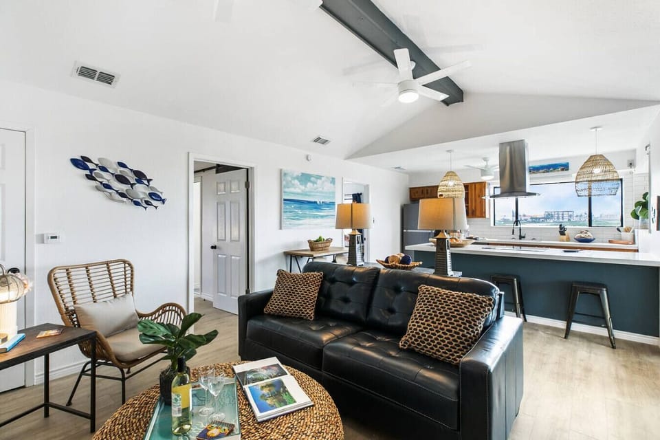- Spacious lounge with island kitchen and bar seating - Stainless steel appliances, quartz counters and bay views - Perfect coastal getaway for relaxing extended stays