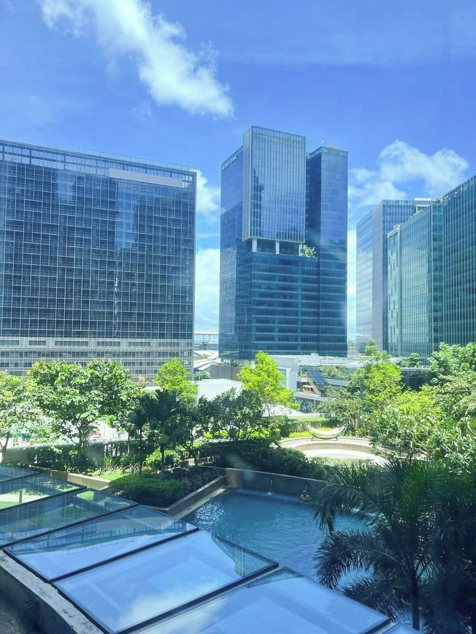 City and pool view from the window at day.