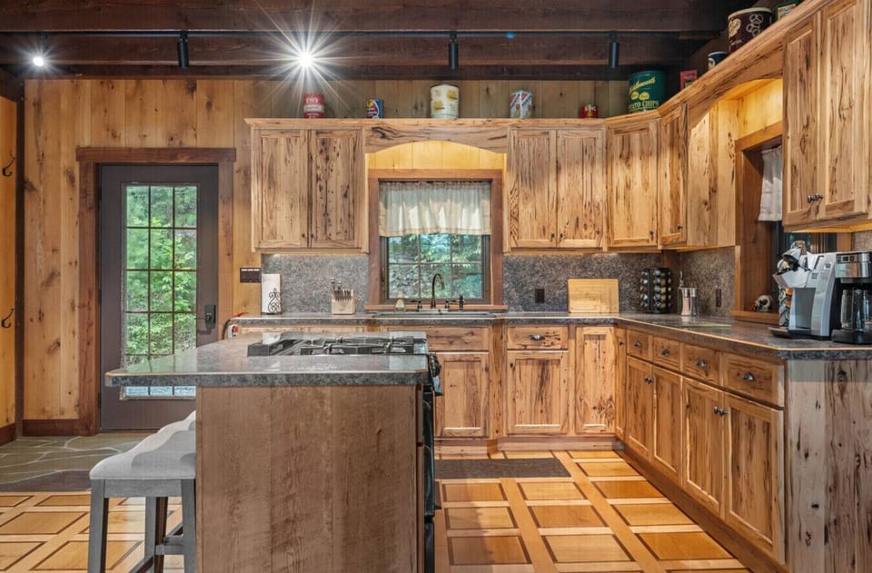 Fully Stocked Kitchen with Island with 3 barstools.