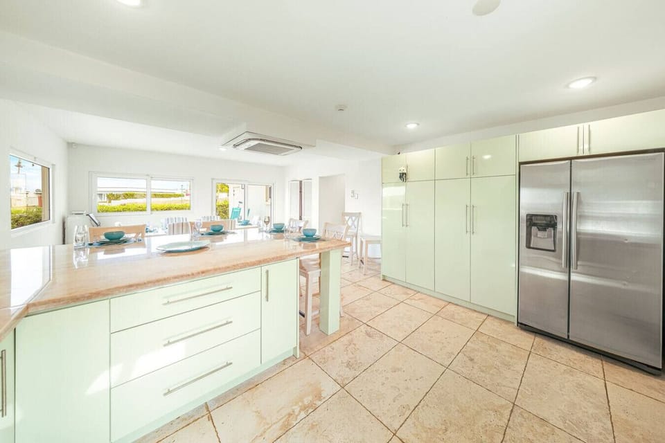Welcome to your culinary haven! This fresh and modern kitchen is perfect for crafting delicious meals while soaking in the sunshine and enjoying the view.