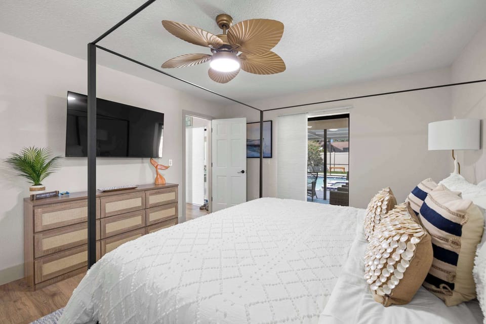 Primary Bedroom: This spacious retreat features a king bed, peaceful coastal touches, and direct walkout access to the pool—making it easy to step outside and enjoy a quiet morning or evening swim.