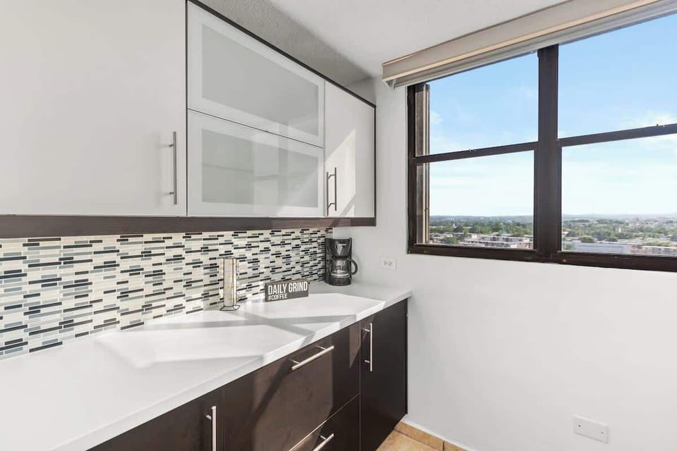 Modern kitchen with beautiful countertops & a scenic view.