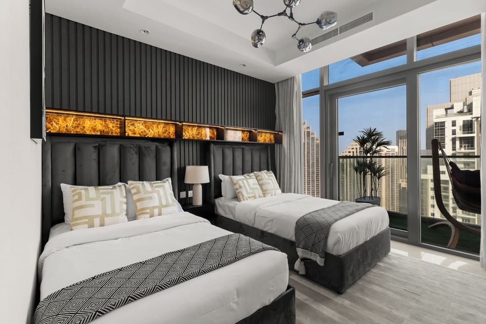 Cozy second bedroom with premium bedding and relaxing city views.