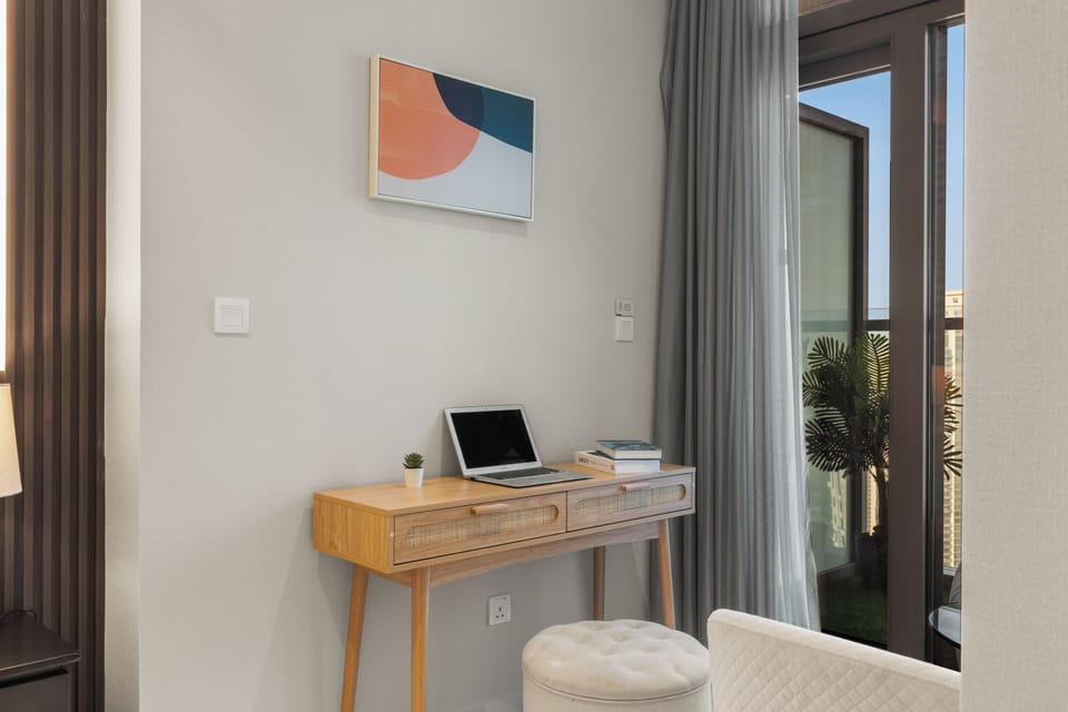Cozy master bedroom with premium bedding and relaxing city views.