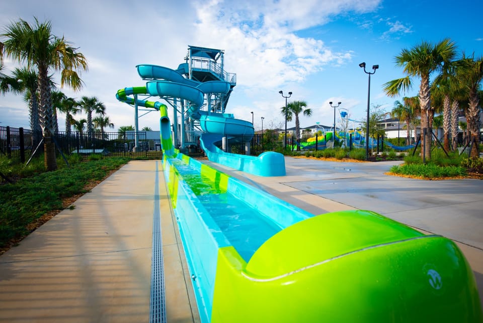 The Retreat Clubhouse, less than 1 mile from the house. Featuring zero entry pool, bar & restaurant, splash pad and waterpark slides! Free access for all guests!