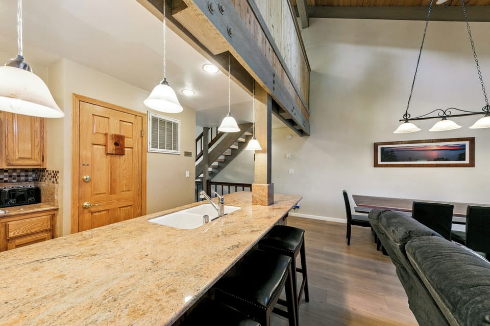 Gather around your spacious granite island for meals and conversation in this open loft-style space with rustic beams.