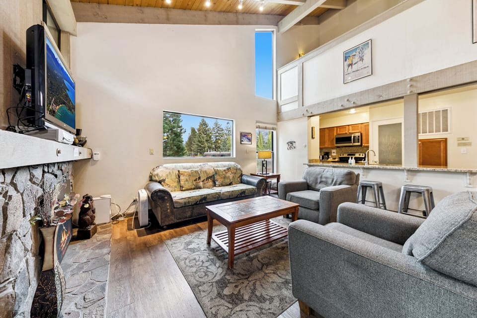 A vaulted ceiling in the living room opens to a cozy loft above.