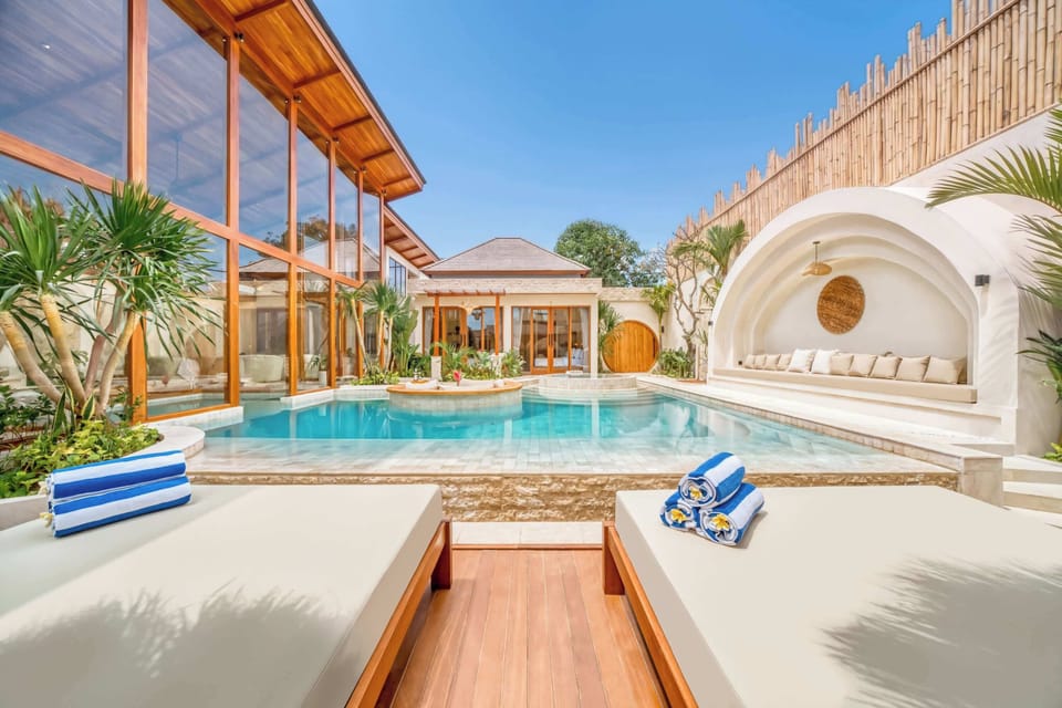 Private paradise with sunbeds, calm waters, and endless blue skies