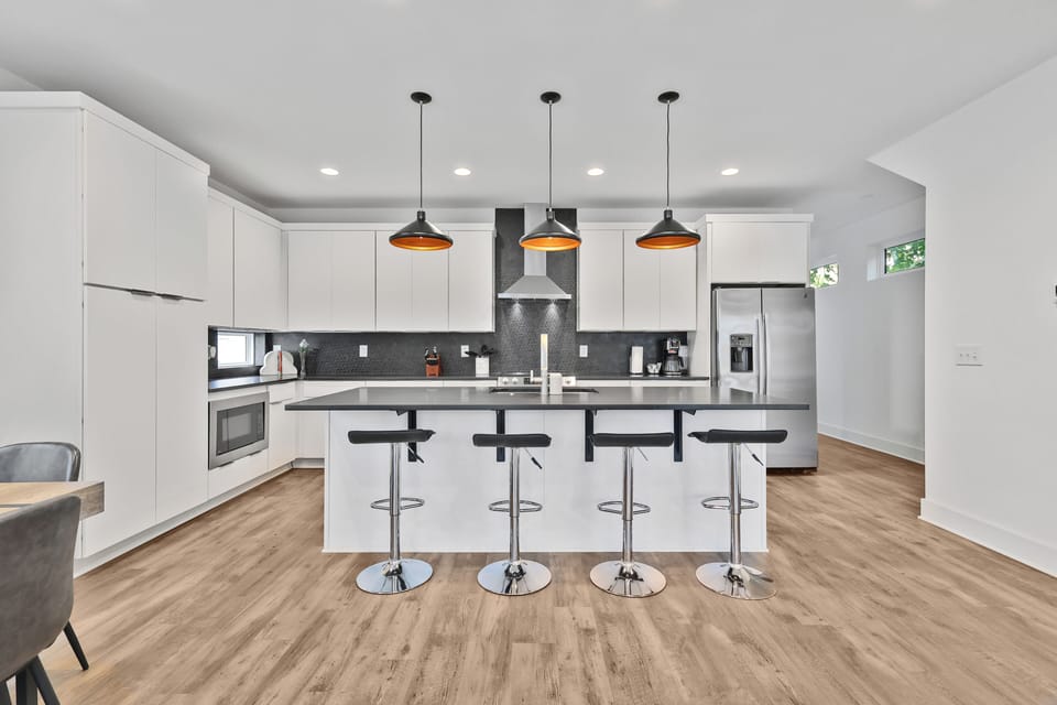 Sleek modern kitchen with pendant lights and breakfast bar seating