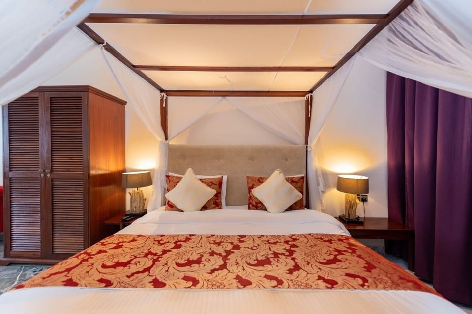 Drift off in soft light beside warm lamps and luxe textiles.