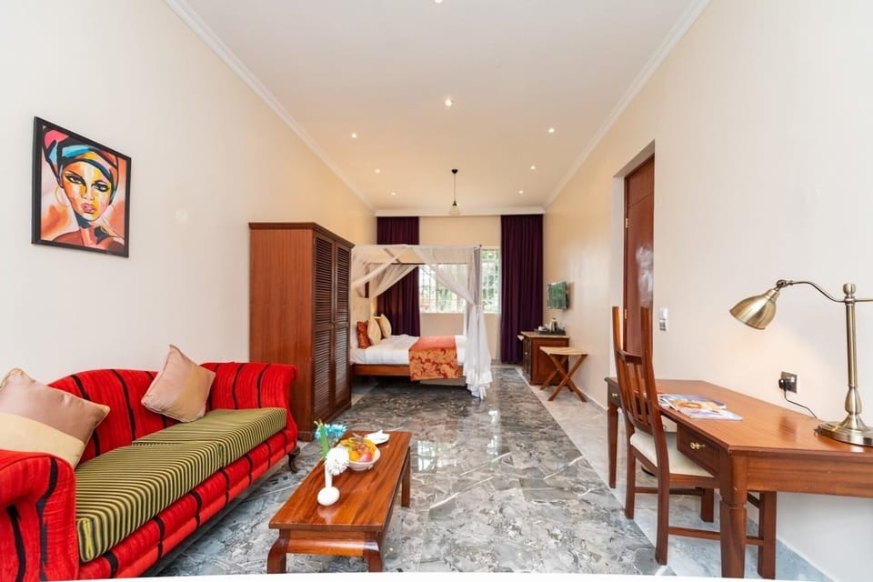 Settle into a spacious suite with sofa, desk, and restful bed.