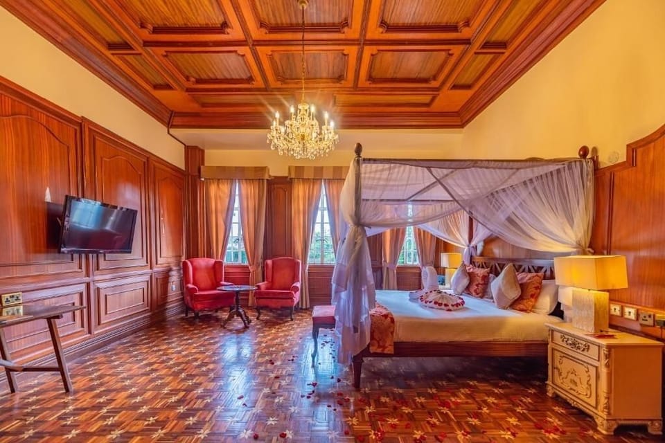 Stretch out in a palatial suite with chandelier and lounge chairs.