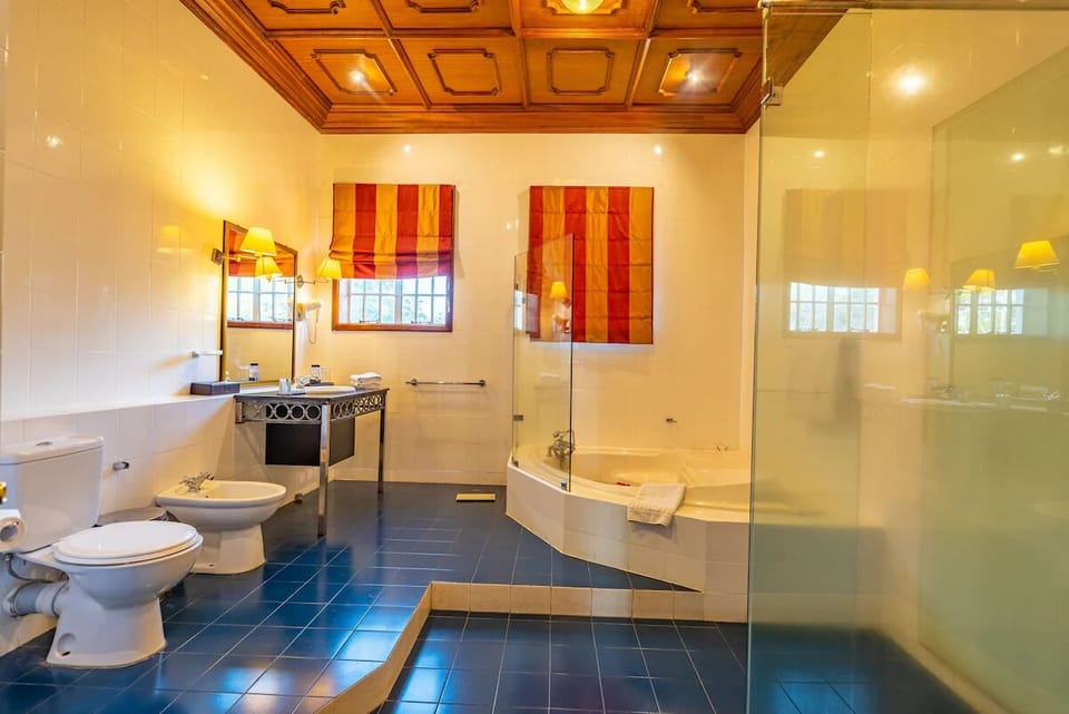 Refresh in a bright bath with glass shower and soaking tub.