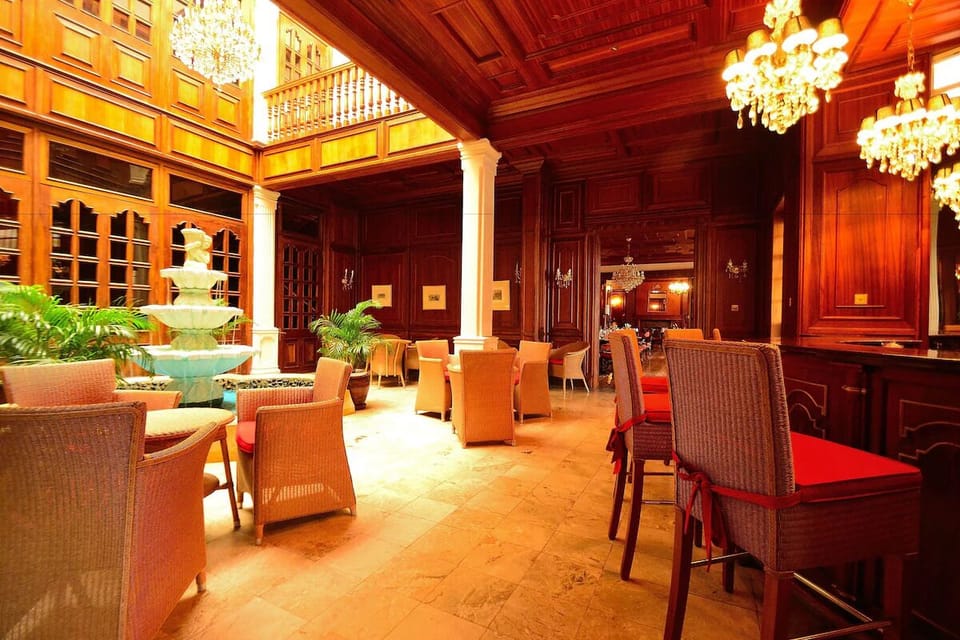 Settle in by the fountain beneath glowing chandeliers and woodwork.
