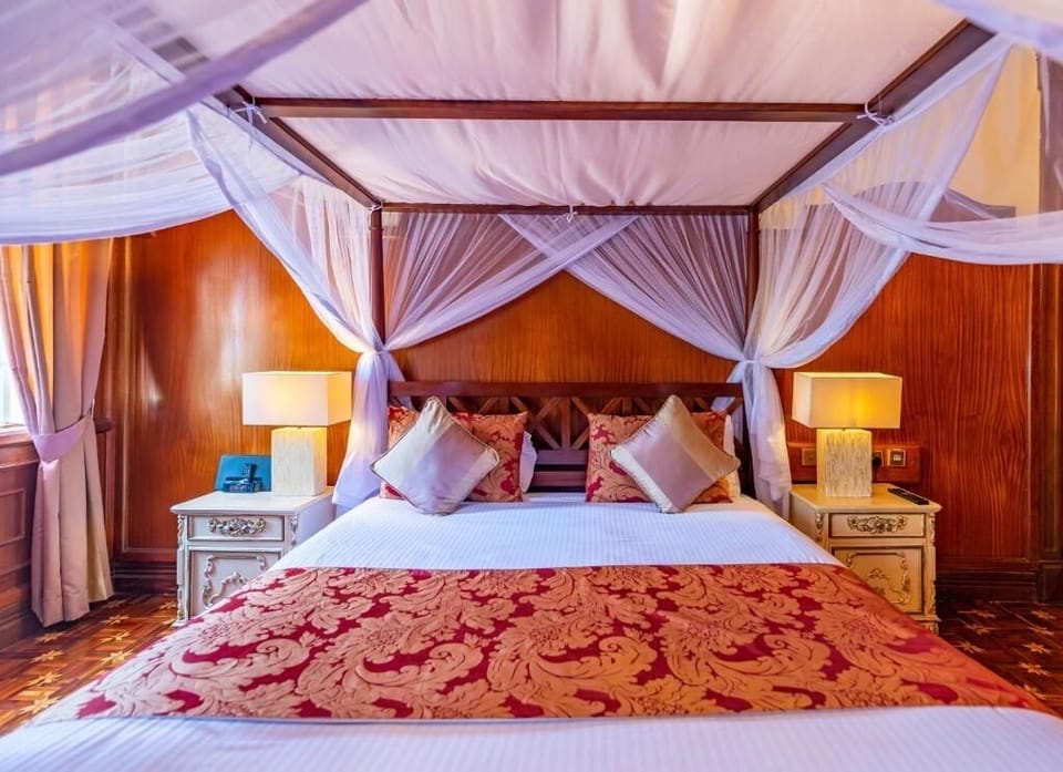 Sink into crisp linens under a dreamy four-poster canopy.
