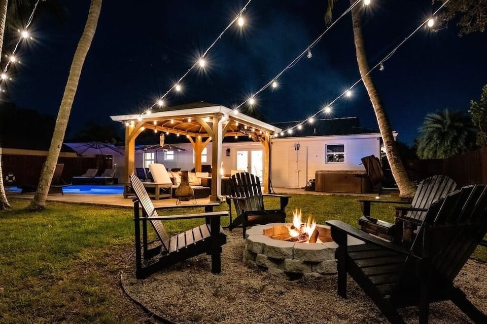 Natural wood fire pit with 4 Adirondack chairs