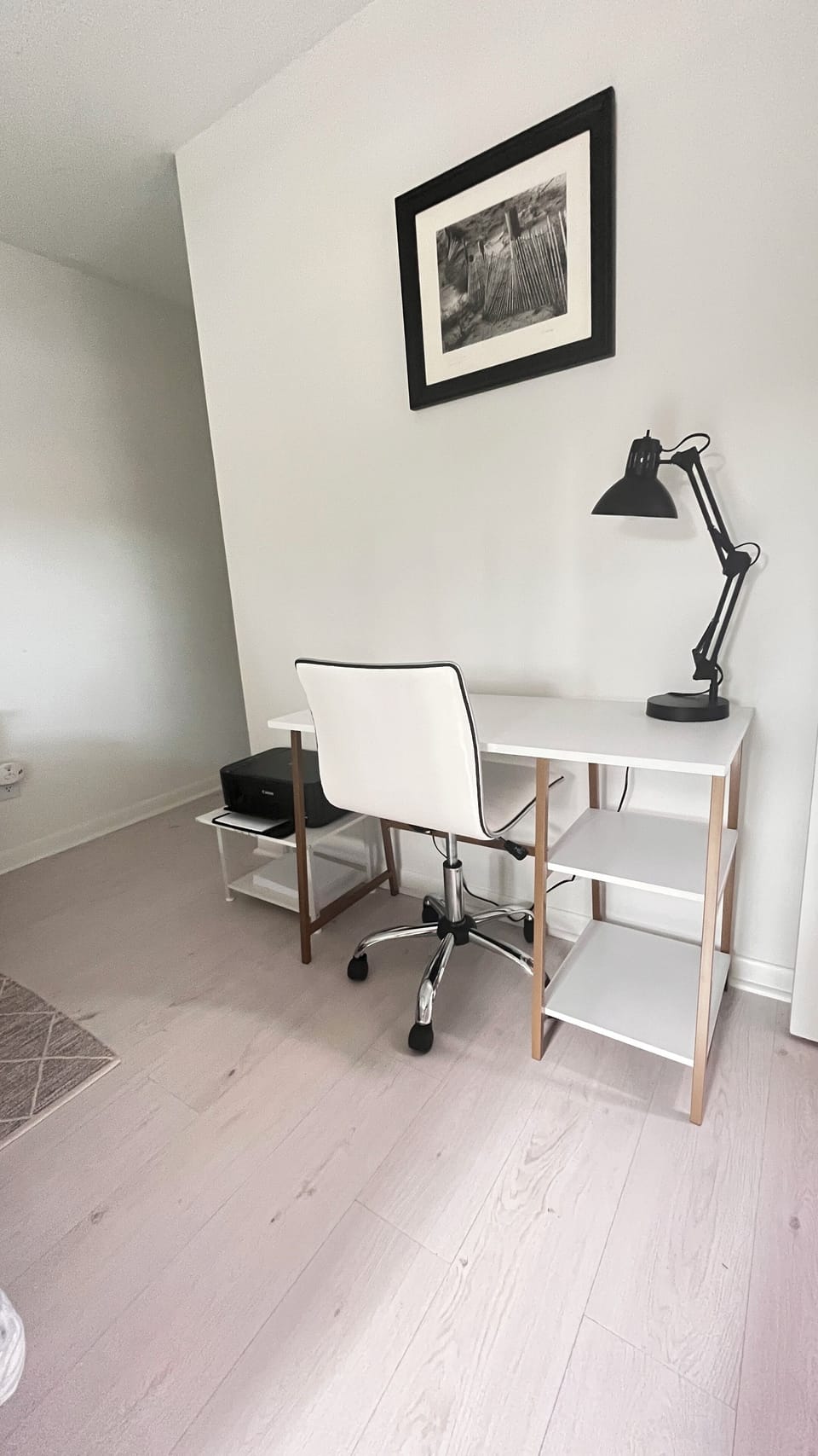 Desk with ergonomic chair and printer/scanner.