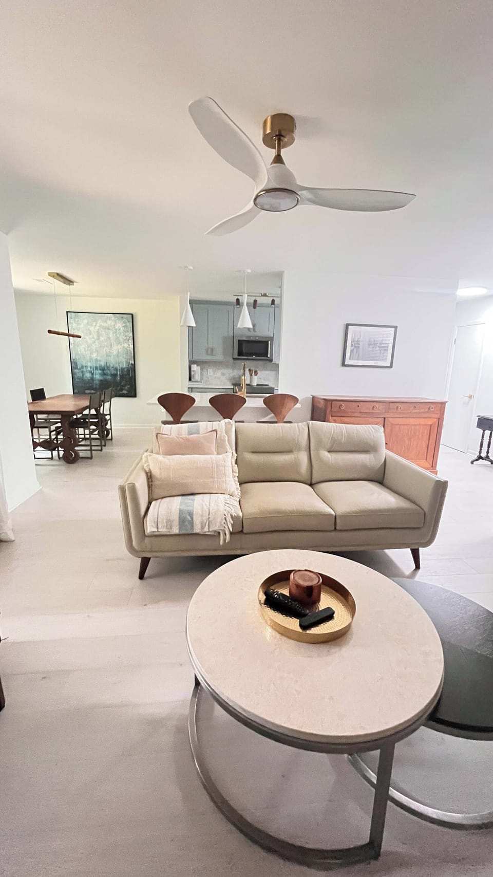 Open modern living room with screen porch access.