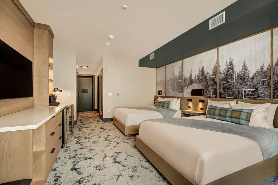 Warm, well-appointed queen room featuring comfortable furnishings for a restful alpine stay.