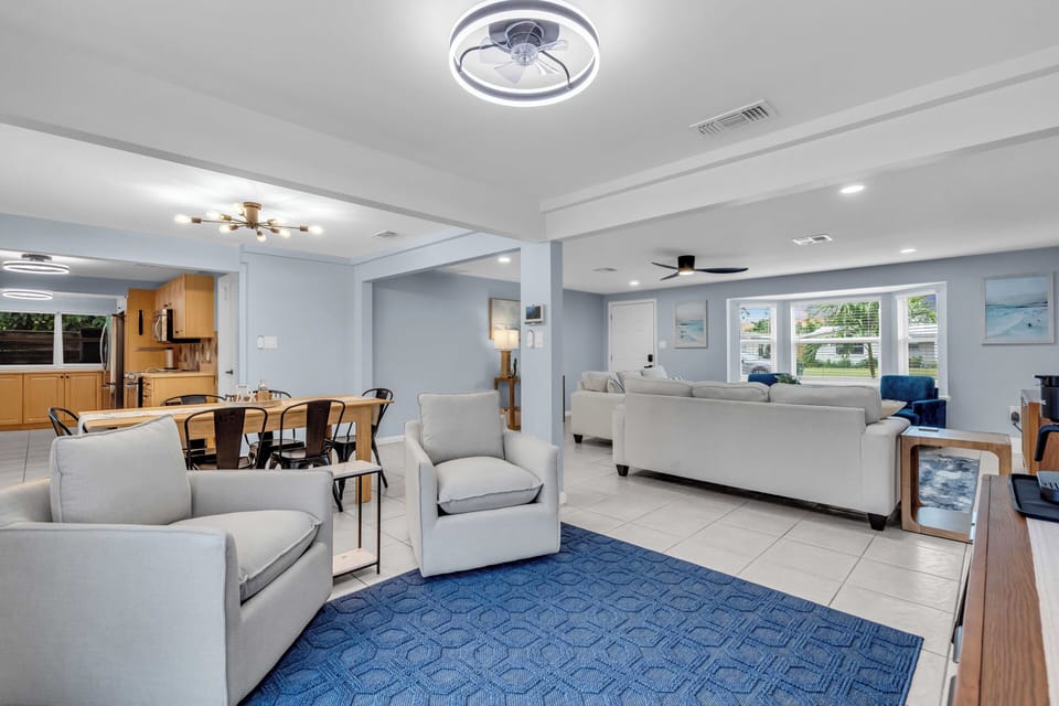 The living room, dining area + coffee bar are all open + just off of the kitchen