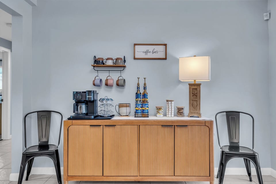 Coffee bar stocked with a Keurig single or full pot combo coffee machine. 
