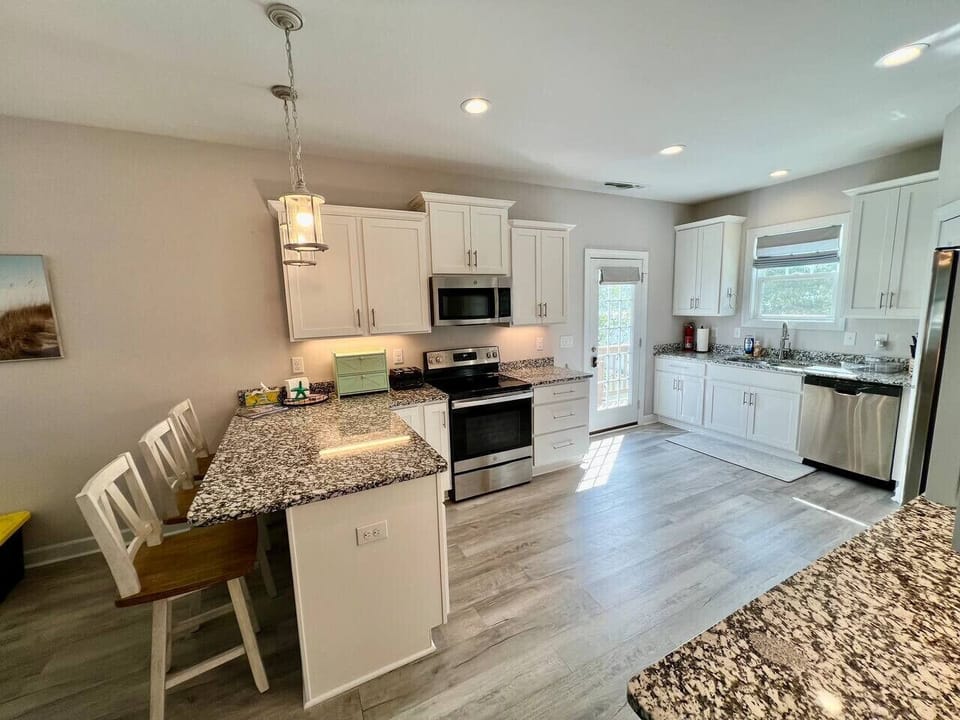 Spacious kitchen with all new appliances, cooking essentials, and large pantry.