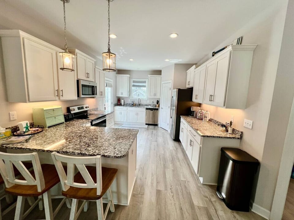 Spacious kitchen with all new appliances, cooking essentials, and large pantry.