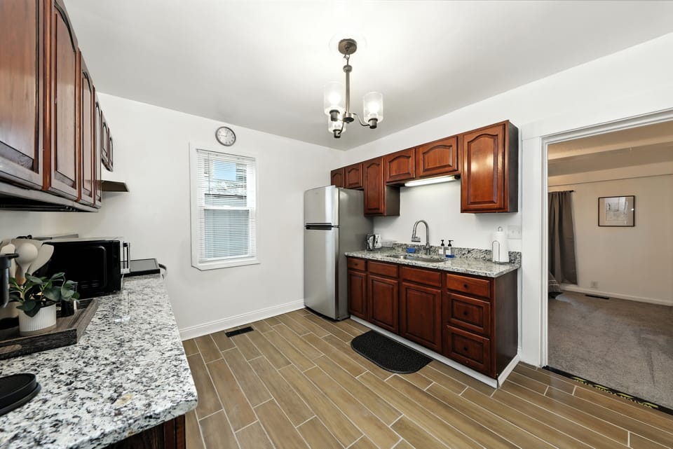 full kitchen with cookware, microwave and oven