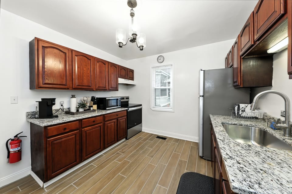 full kitchen with cookware, microwave and oven