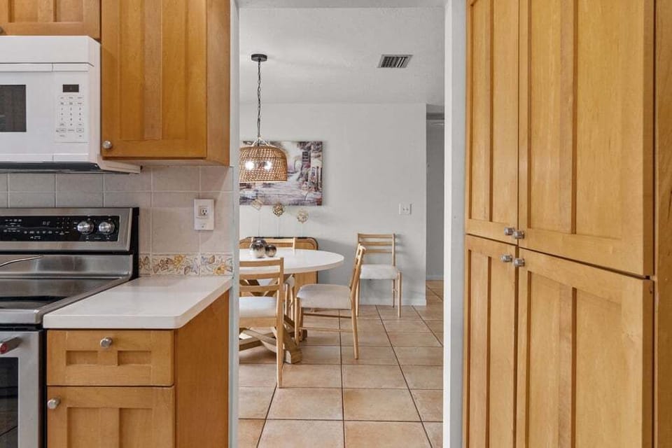 Fully equipped kitchen with poolside and canal views, making cooking a pleasure