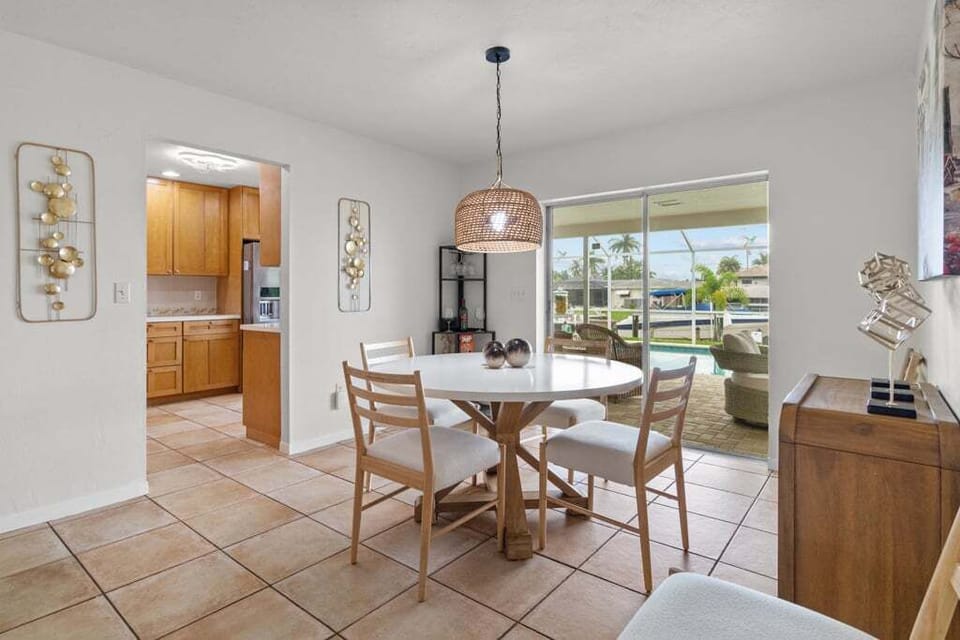 Dining area with pool and waterfront views, perfect for family meals or morning coffee.