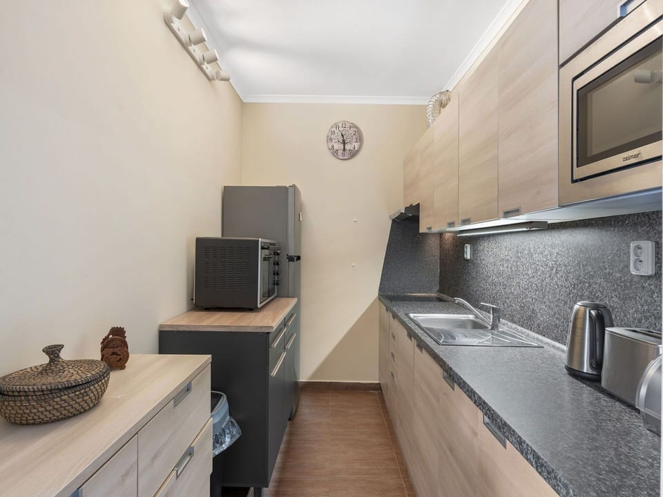Countertop, Furniture, Kitchen, Cabinetry, Interior Design, Flooring, Major Appliance, Kitchen Appliance, Wood, Floor